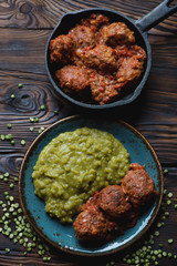 Poster - Top view of meatballs in tomato sauce with boiled green peas