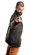 © luismolinero - Man wearing a leather jacket pointing to the front