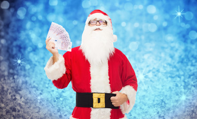 Wall Mural - man in costume of santa claus with euro money