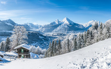 Idyllic Winter Landscape In The Alps With Traditional Mountain Chalet