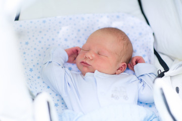 Wall Mural - sleeping newborn baby boy in a stroller