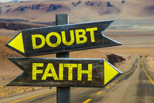 Doubt - Faith Signpost In A Desert Road On Background
