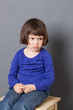 © STUDIO GRAND WEB - kid attitude concept - thinking 4-year old child sulking on a stool for discipline or calming down in the corner for bad behavior,studio shot