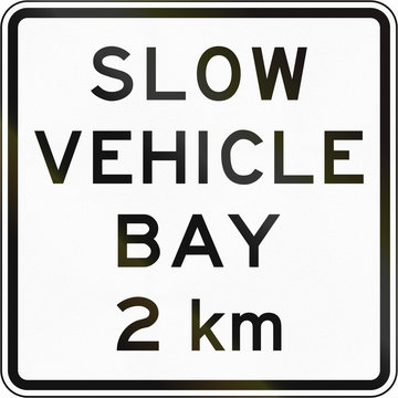 New Zealand road sign - Slow vehicle bay ahead in 2 kilometres