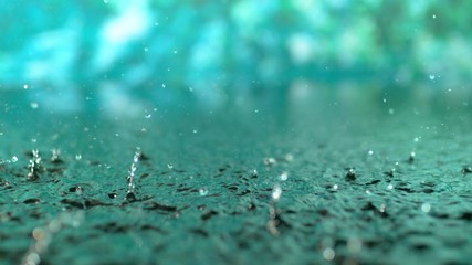 4k 30fps, heavy rain in puddle with green background shot with high speed camera, phantom flex 4k.