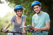 © highwaystarz - Young Couple Looking At Map Whilst On Cycle Ride