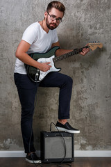 Wall Mural - Stylish guy with a guitar