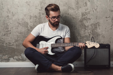 Wall Mural - Stylish guy with a guitar