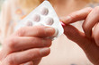 Close Up Of Woman Opening Packet Of Pills