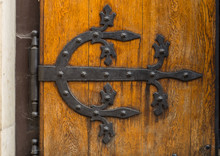 Ancient Wooden Door With Decorative Hinge Forged In Steel