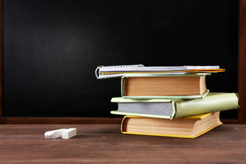 Wall Mural - School equipment on desk on blackboard background