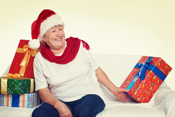 Wall Mural - happy elderly woman with christmas box gift - holiday concept