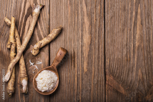 Fotografie, Obraz Seasoning of grated horseradish with space for text
