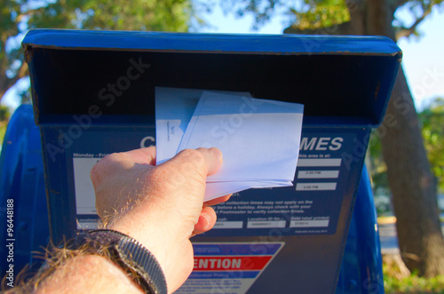 Fotografie, Obraz Putting letters in an outdoor metal mailbox