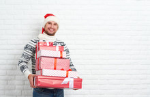 Happy Man With Christmas Gifts On Blank Wall