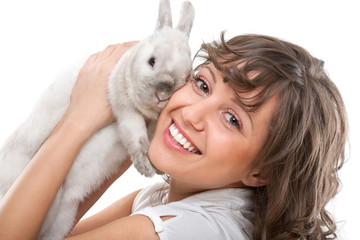 Wall Mural - Young woman kissing rabbit