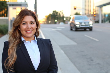 image of beautiful latin businesswoman while standing on the road