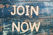 Join now written with wooden letters on rustic surface
