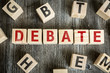 Wooden Blocks with the text: Debate