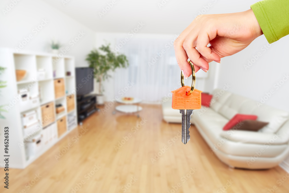 Hand with house key.