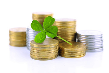 Wall Mural - Clover leaf and stacks of coins isolated on white