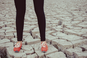 Canvas Print - sport, fitness, people and lifestyle concept - red sneakers on girl legs on the desert background