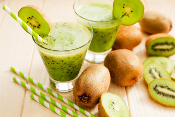 Wall Mural - Fruit smoothie with fresh green kiwi on a wooden background