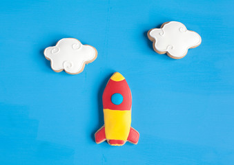 homemade gingerbread cookies in the shape of spaceship and clouds
