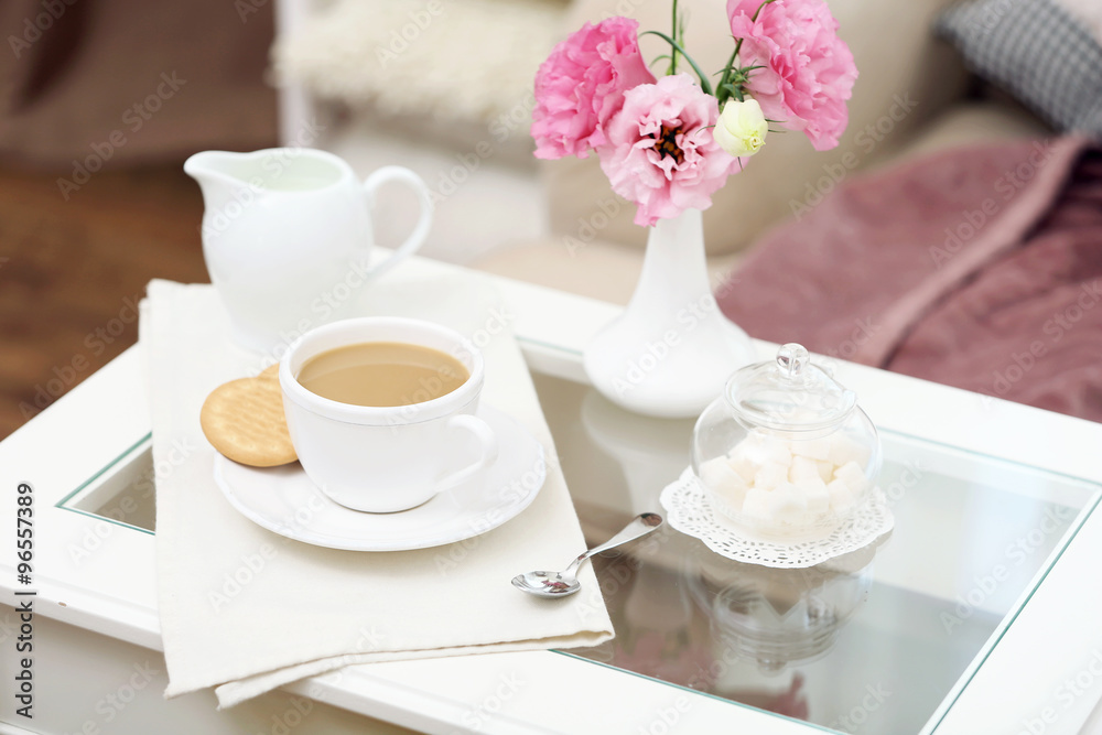 Cup of coffee on table in living room
