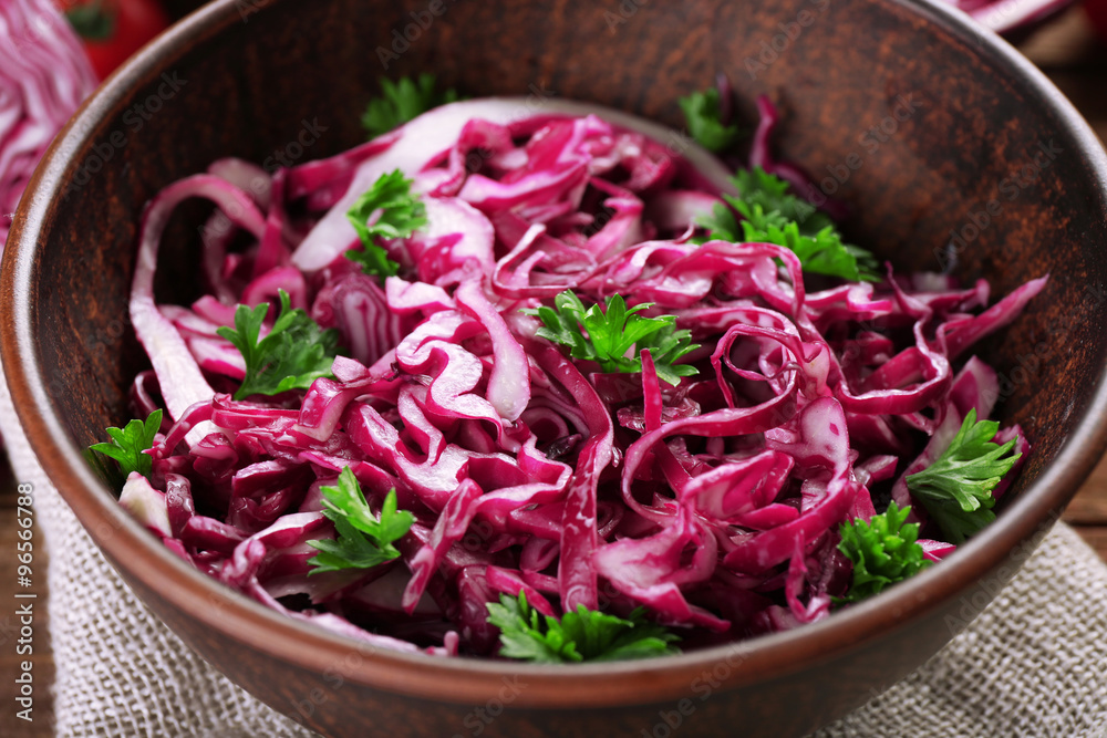 Red cabbage salad served on plate closeup