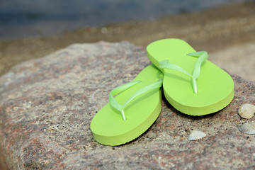 Sticker - Bright flip-flops on stone, nature background