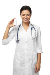 Poster - Smiling medical doctor holding pills isolated on white