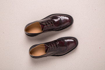 New pair of man brogues shoes on a gray background.