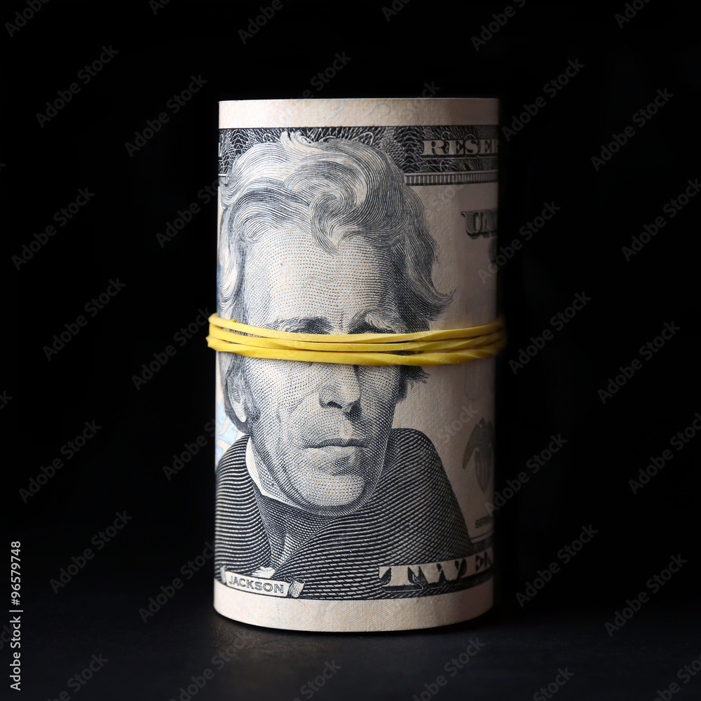 Dollars roll on black background