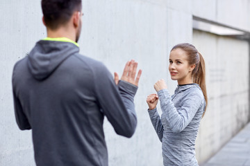 Canvas Print - happy woman with coach working out strike outdoors