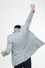 Back view portrait of a businessman celebrating his success