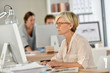 © goodluz - Smiling senior businesswoman working in office