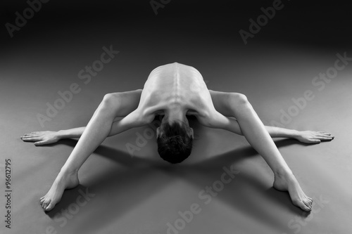 Fotografering Naked yoga. Beautiful sexy body of young woman on gray background