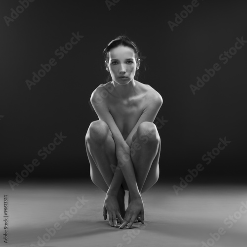 Naked yoga. Beautiful sexy body of young woman on gray background Billede på lærred