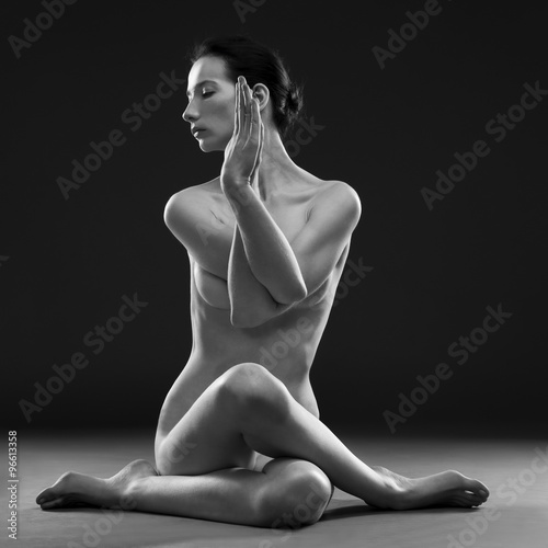 Fotografering Naked yoga. Beautiful sexy body of young woman on gray background