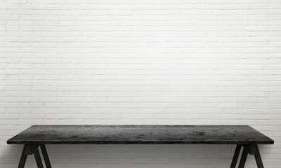 Black wooden table with legs. White brick wall texture in background.