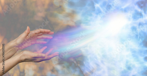 Fotografie, Obraz Soul midwife - female hands on a darkness to light background and a soul energy