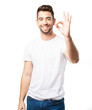 © asierromero - young man doing okay symbol