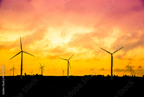 Fotografie, Obraz Wind farm at sunset, Alternative energy concept, instagram style retro processin