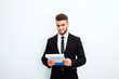 © kanashkin - Portrait of an handsome businessman with a folder