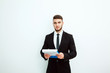 © kanashkin - Portrait of an handsome businessman with a folder