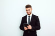 © kanashkin - Portrait of an handsome businessman with a tablet