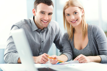 Poster - Young couple working together