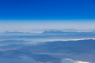 Deep blue sky above landscape with mountains and sea,atmospheric aerial photography