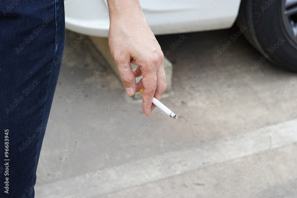 cigarette in left hand of woman Stock Photo